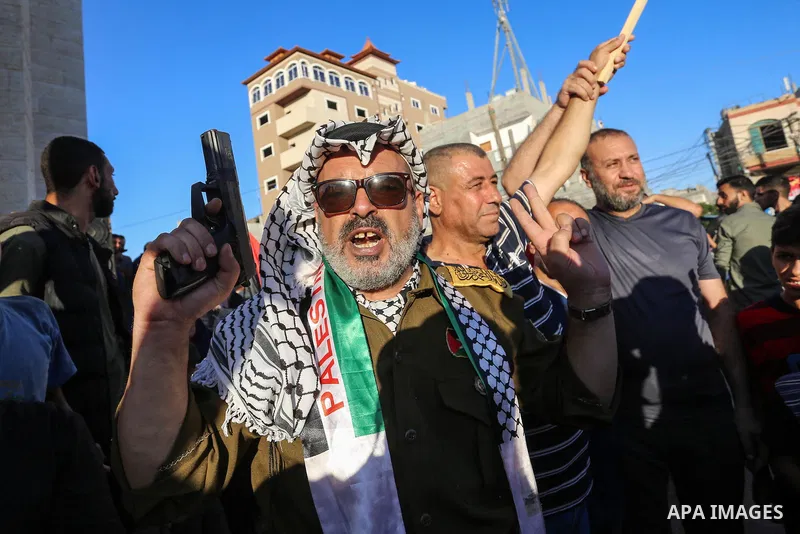 Palestinians carry pictures of Palestinian President Mahmoud Abbas during a protest against the United Arab Emirates' deal with Israel to normalise relations, in Rafah in the southern of Gaza Strip, on August 20, 2020. P...