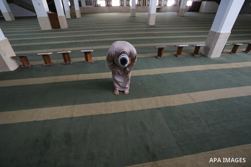Palestinian imam of the mosque prays at a mosque is empty of worshipers, after it was shut down as a precaution against the spread of the coronavirus COVID-19, during a 48 hour lockdown imposed following the discovery of...