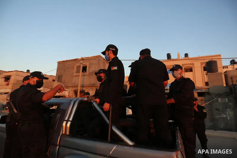 Palestinian policemen wear face masks as they guard in a street during the imposed 48-hour lockdown to mitigate virus outbreak in the Gaza Strip, in Dair Al Balah in the central of Gaza Strip on August 26, 2020. Photo by...