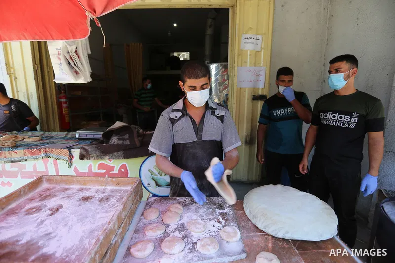 Palestinian workers wear face masks during their work during the imposed lockdown to mitigate virus outbreak in the Gaza Strip, in Dair Al Balah in the central of Gaza Strip on August 27, 2020, during a lockdown in the P...