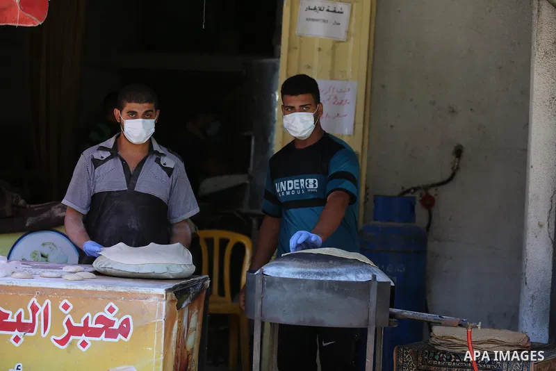 Palestinian workers wear face masks during their work during the imposed lockdown to mitigate virus outbreak in the Gaza Strip, in Dair Al Balah in the central of Gaza Strip on August 27, 2020, during a lockdown in the P...