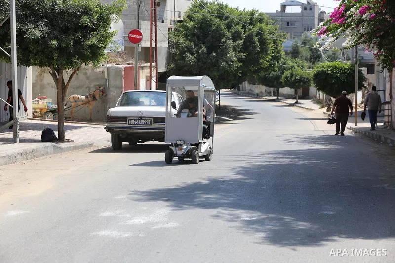 Palestinians wear face masks as they walk in a street during the imposed lockdown to mitigate virus outbreak in the Gaza Strip, in Dair Al Balah in the central of Gaza Strip on August 27, 2020, during a lockdown in the P...