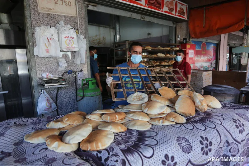 Palestinian workers wear face masks during their work during the imposed lockdown to mitigate virus outbreak in the Gaza Strip, in Dair Al Balah in the central of Gaza Strip on August 27, 2020, during a lockdown in the P...