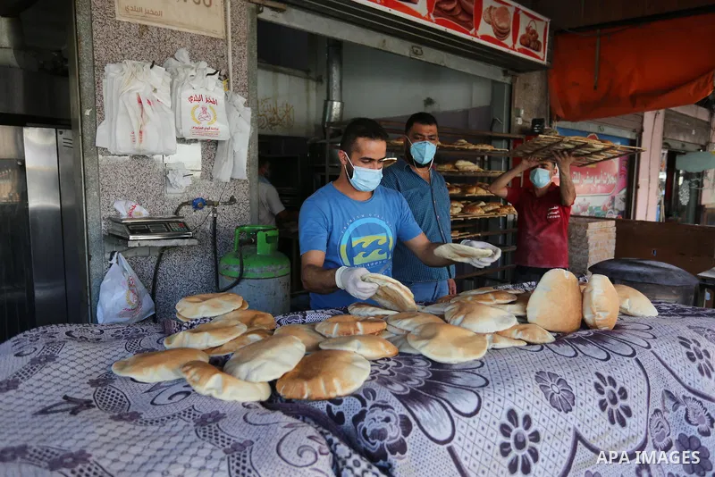 Palestinian workers wear face masks during their work during the imposed lockdown to mitigate virus outbreak in the Gaza Strip, in Dair Al Balah in the central of Gaza Strip on August 27, 2020, during a lockdown in the P...