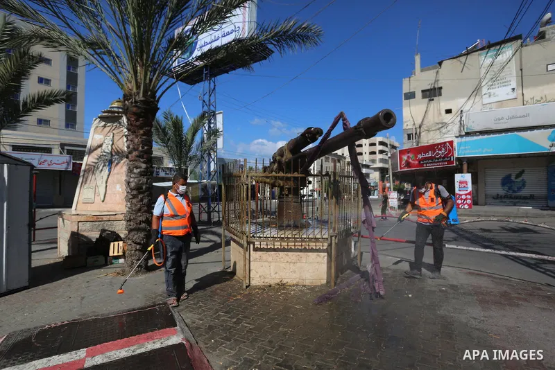 Palestinian workers wearing protective gear, disinfect a streets, during the imposed lockdown to mitigate virus outbreak in the Gaza Strip, in Dair Al Balah in the central of Gaza Strip on August 27, 2020, during a lockd...