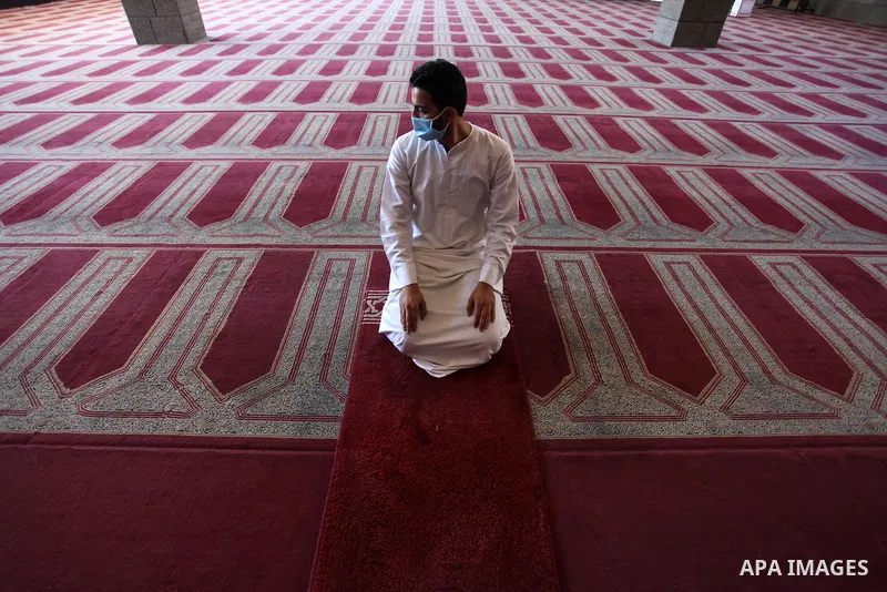 Palestinian imam of the mosque prays at a mosque is empty of worshipers, during the imposed lockdown to mitigate virus outbreak in the Gaza Strip, in Gaza city on August 28, 2020, during a lockdown in the Palestinian enc...