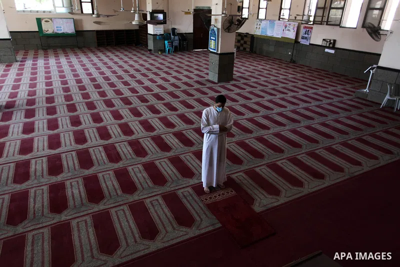 Palestinian imam of the mosque prays at a mosque is empty of worshipers, during the imposed lockdown to mitigate virus outbreak in the Gaza Strip, in Gaza city on August 28, 2020, during a lockdown in the Palestinian enc...