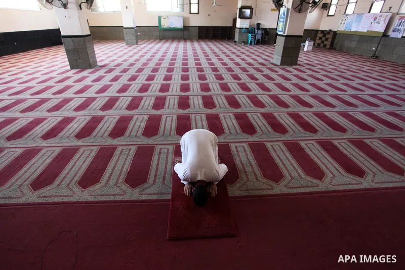 Palestinian imam of the mosque prays at a mosque is empty of worshipers, during the imposed lockdown to mitigate virus outbreak in the Gaza Strip, in Gaza city on August 28, 2020, during a lockdown in the Palestinian enc...