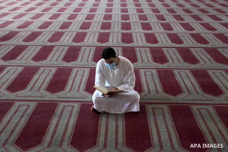Palestinian imam reads Koran at a mosque is empty of worshipers during the imposed lockdown to mitigate virus outbreak in the Gaza Strip, in Gaza city on August 28, 2020, during a lockdown in the Palestinian enclave due...