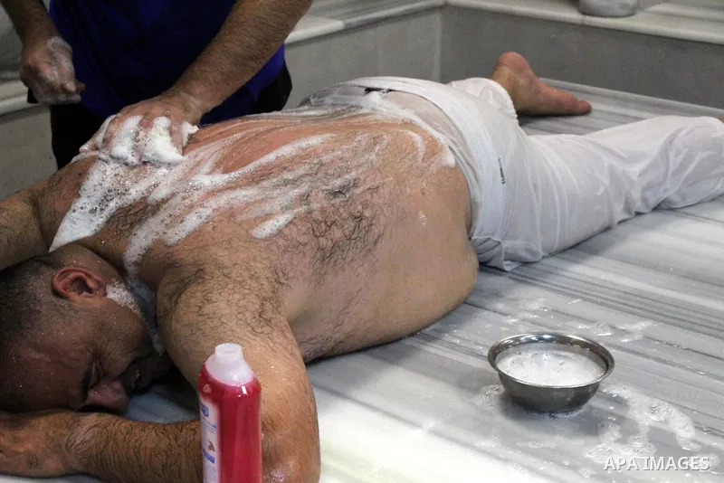 Palestinians bathe together in a pool at a Hammam (Turkish-style bathhouse) in the West Bank city of Hebron, on August 28, 2020, at which groups of ten are admitted at a time to reduce congestion as part of COVID-19 coro...