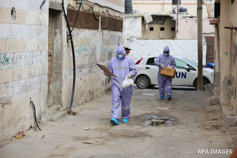 Palestinian nurses from the United Nations Relief and Works Agency for Palestinian Refugees "UNRWA" wearing protective gear, they distribute monthly treatment to chronic diseases, in Dair Al Balah in the central of Gaza...