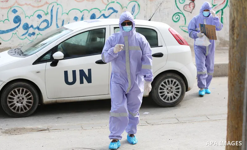 Palestinian nurses from the United Nations Relief and Works Agency for Palestinian Refugees "UNRWA" wearing protective gear, they distribute monthly treatment to chronic diseases, in Dair Al Balah in the central of Gaza...