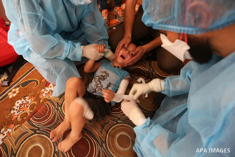 Palestinian nurses from the Palestinian Red Crescent Society wearing protective gear, provide medical services to patients in their homes in Dair Al Balah in the central of Gaza Strip, on August 30, 2020, during a lockdo...