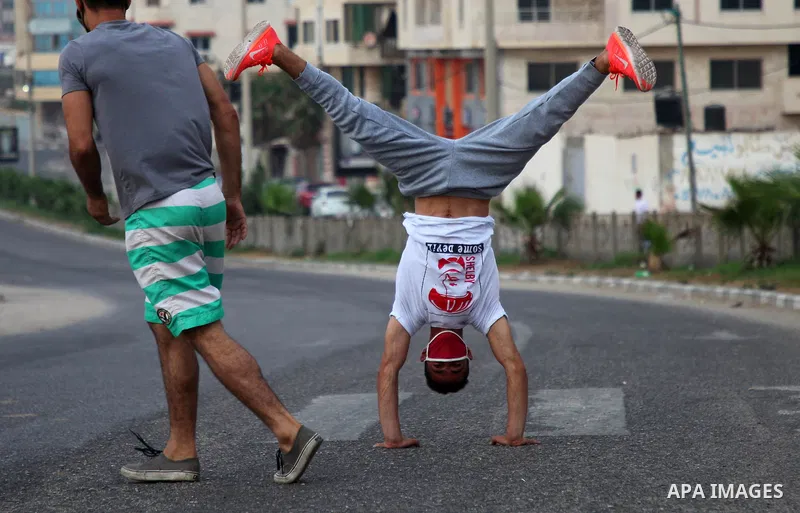 Palestinian Parkour players wear face masks show off their skills on a nearly deserted street during the imposed lockdown to mitigate virus outbreak in the Gaza Strip, in Gaza city on September 4, 2020. Photo by Mahmoud...