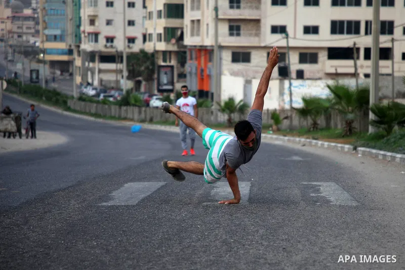 Palestinian Parkour players wear face masks show off their skills on a nearly deserted street during the imposed lockdown to mitigate virus outbreak in the Gaza Strip, in Gaza city on September 4, 2020. Photo by Mahmoud...