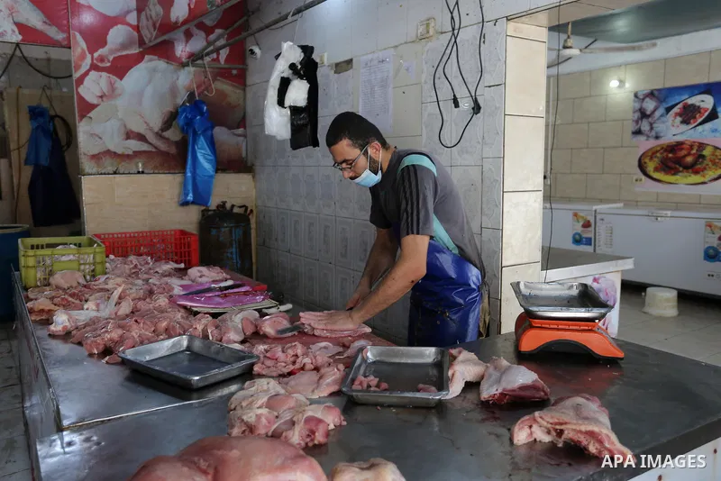 A Palestinian man wear protective face mask, as he sells meats during a lockdown following the outbreak of the coronavirus disease (COVID-19), in Dair Al Balah in the central of Gaza Strip, on September 6, 2020. Photo by...