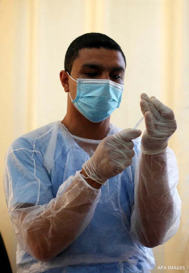 A UNRWA employee wears face mask as he provides Polio vaccine and Rota virus vaccines for children in a clinic in Bureij refugee camp central of Gaza Strip on September 9, 2020. Photo by Mahmoud Ajjour