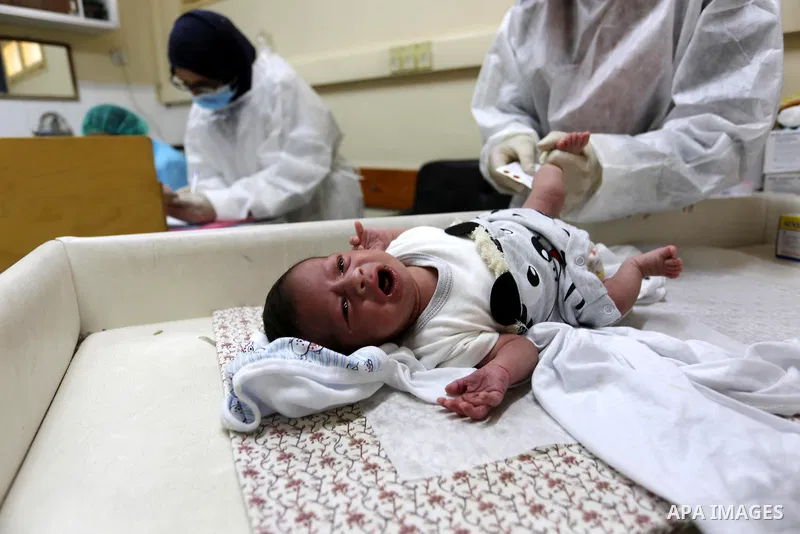 Palestinian employees wear face masks as they provide Polio vaccine and Rota virus vaccines for children at a health center in Dair Al Balah in the central of Gaza Strip, on Sept. 9, 2020. Photo by Ashraf Amra