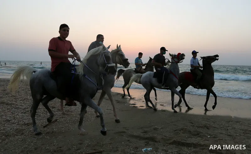 Palestinians enjoy at the beach, amid the coronavirus disease (COVID-19) outbreak, in Dair Al Balah in the central of Gaza Strip on September 11, 2020. Photo by Ashraf Amra