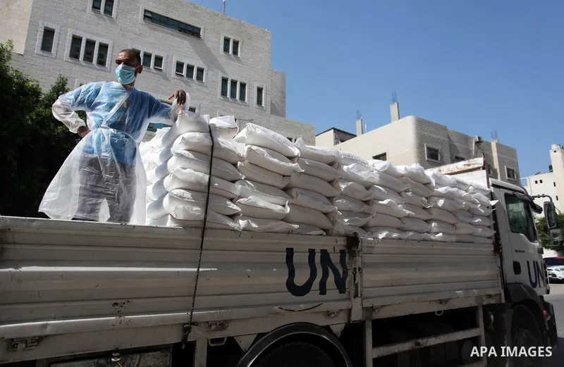UNRWA employees wearing protective masks and gloves, transport food aid to refugee family homes, amid the coronavirus disease (COVID-19), in Gaza city, on September 15, 2020. Photo by Mahmoud Ajjour