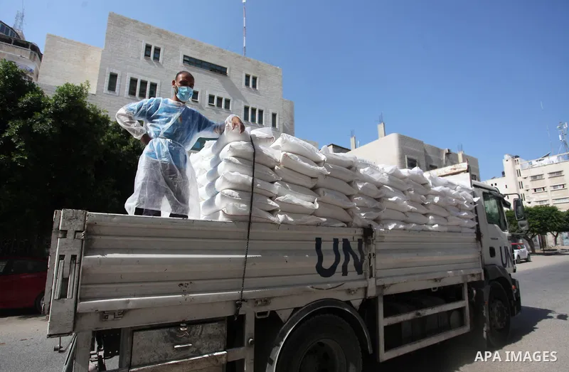 UNRWA employees wearing protective masks and gloves, transport food aid to refugee family homes, amid the coronavirus disease (COVID-19), in Gaza city, on September 15, 2020. Photo by Mahmoud Ajjour