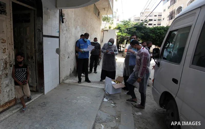 UNRWA employees wearing protective masks and gloves, transport food aid to refugee family homes, amid the coronavirus disease (COVID-19), in Gaza city, on September 15, 2020. Photo by Mahmoud Ajjour