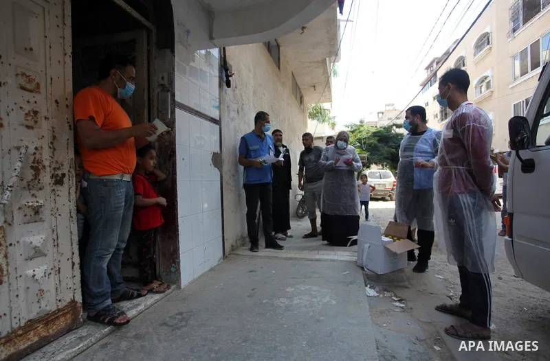 UNRWA employees wearing protective masks and gloves, transport food aid to refugee family homes, amid the coronavirus disease (COVID-19), in Gaza city, on September 15, 2020. Photo by Mahmoud Ajjour