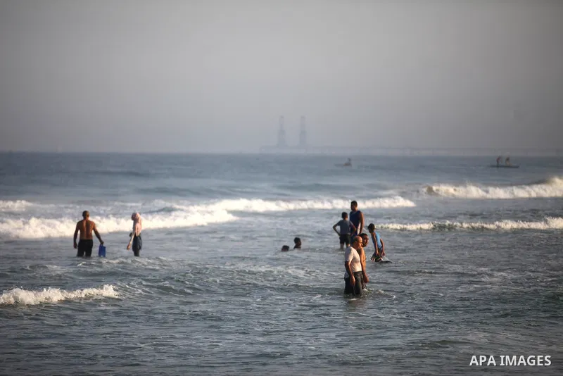 Palestinians swim at a beach in Beit Lahia in the northern Gaza Strip on September 29, 2020. Photo by Mahmoud Ajjour