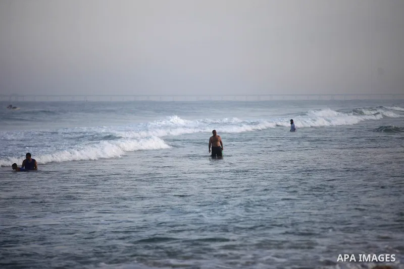 Palestinians swim at a beach in Beit Lahia in the northern Gaza Strip on September 29, 2020. Photo by Mahmoud Ajjour