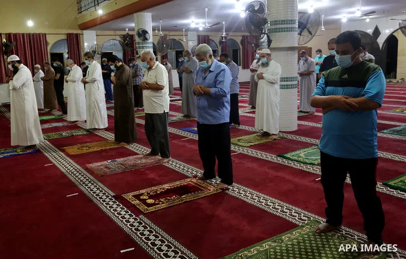 Palestinians wear face masks as a precaution due to the COVID-19 coronavirus pandemic, pray in a mosque as the holy places reopen to worshippers to perform the weekly Islamic ritual, in Deir al-Balah in the central of Ga...
