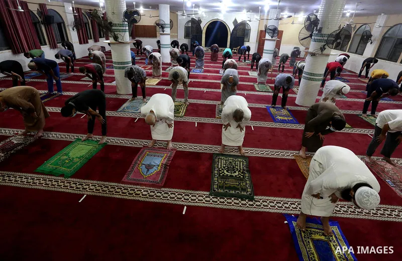 Palestinians wear face masks as a precaution due to the COVID-19 coronavirus pandemic, pray in a mosque as the holy places reopen to worshippers to perform the weekly Islamic ritual, in Deir al-Balah in the central of Ga...