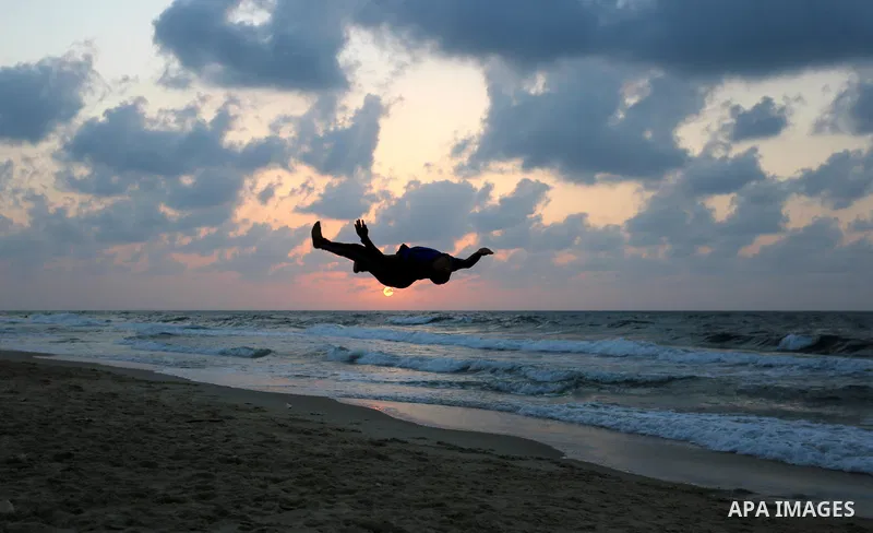 Palestinians enjoy the beach along the shore of the Mediterranean Sea during the sunset in Deir al-Balah in the central Gaza Strip on October 20, 2020. Photo by Ashraf Amra