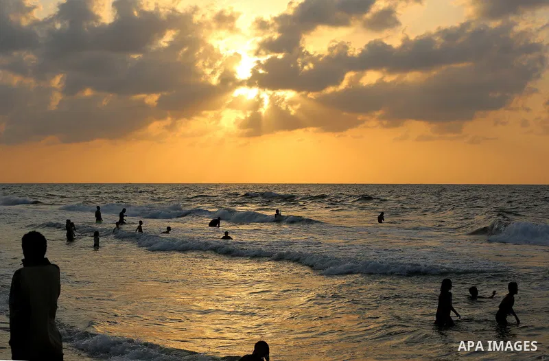 Palestinians enjoy the beach along the shore of the Mediterranean Sea during the sunset in Deir al-Balah in the central Gaza Strip on October 20, 2020. Photo by Ashraf Amra