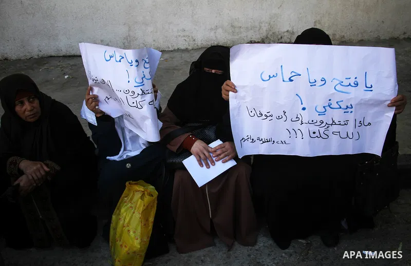 Palestinian families of martyrs and woundeds wearing protective face masks, as they take part in a protest to demand their rights and salaries, in Gaza city, on November 10, 2020. Photo by mohammed salem