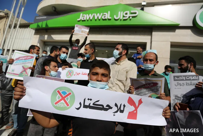 Palestinian protesters take part in a rally in front of the mobile company (jawwal), against the high prices and the bad services of the company in Deir Al-Balah, in the central Gaza Strip, on November 10, 2020. Photo by...