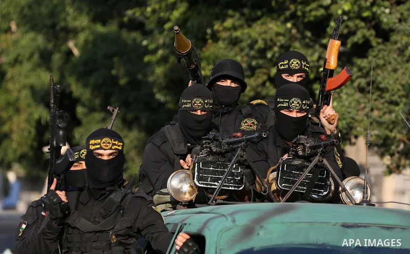 Palestinian Islamic Jihad militants take part in a military rally, to mark the first anniversary of the killing of the group's commander Baha Abu Al-Ata in a strike on his home in the Gaza Strip, in Gaza City on November...