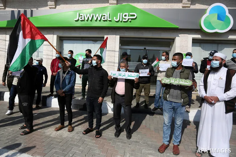 Palestinian protesters take part in a rally in front of the mobile company (jawwal), against the high prices and the bad services of the company, in Nuseirat in the central of Gaza Strip, on November 16, 2020. Photo by A...