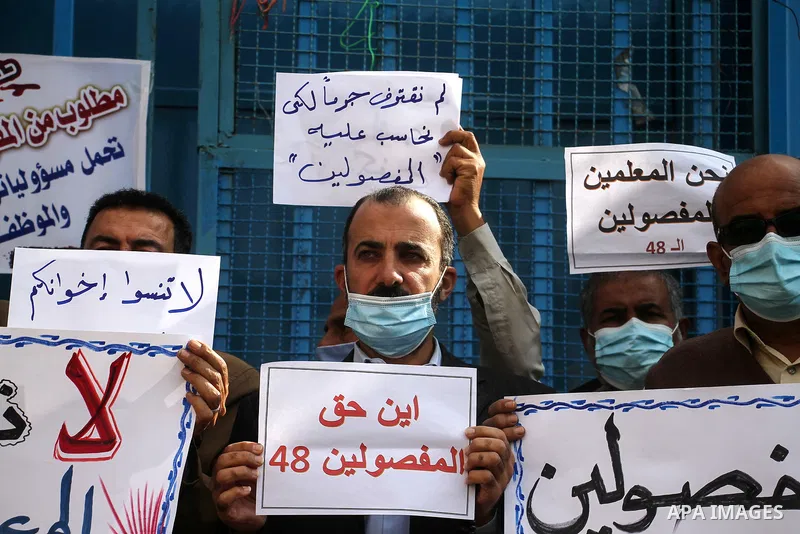 Palestinian employees of United Nations Relief and Works Agency (UNRWA) take part in a protest demanding their rights, outside its headquarter office, in Gaza City, on November 17, 2020. Photo by Mahmoud Ajjour