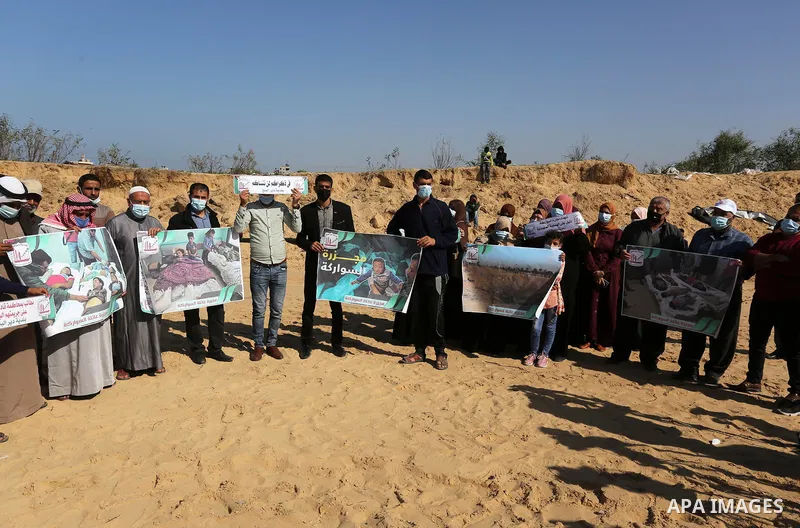Palestinians take part in a protest on the first anniversary of the massacre of the "Al-Sawarka" family who were killed hit by an Israeli airstrike, in Deir al-Balah, central of Gaza Strip on November 19, 2020. Israel sa...
