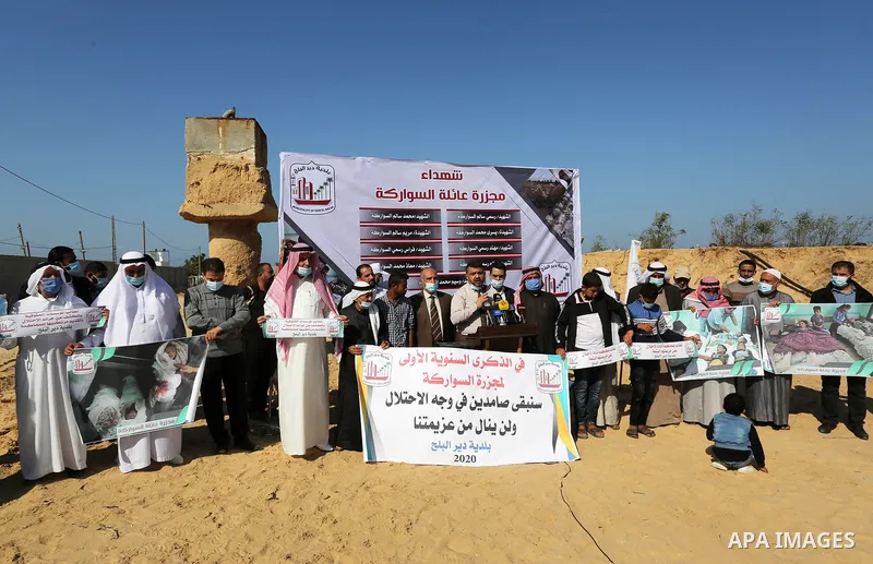 Palestinians take part in a protest on the first anniversary of the massacre of the "Al-Sawarka" family who were killed hit by an Israeli airstrike, in Deir al-Balah, central of Gaza Strip on November 19, 2020. Israel sa...