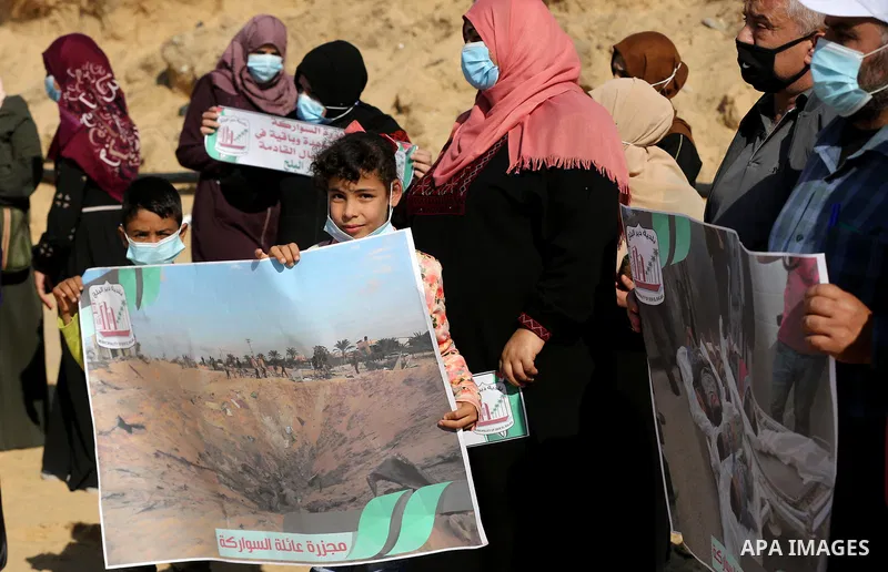 Palestinians take part in a protest on the first anniversary of the massacre of the "Al-Sawarka" family who were killed hit by an Israeli airstrike, in Deir al-Balah, central of Gaza Strip on November 19, 2020. Israel sa...