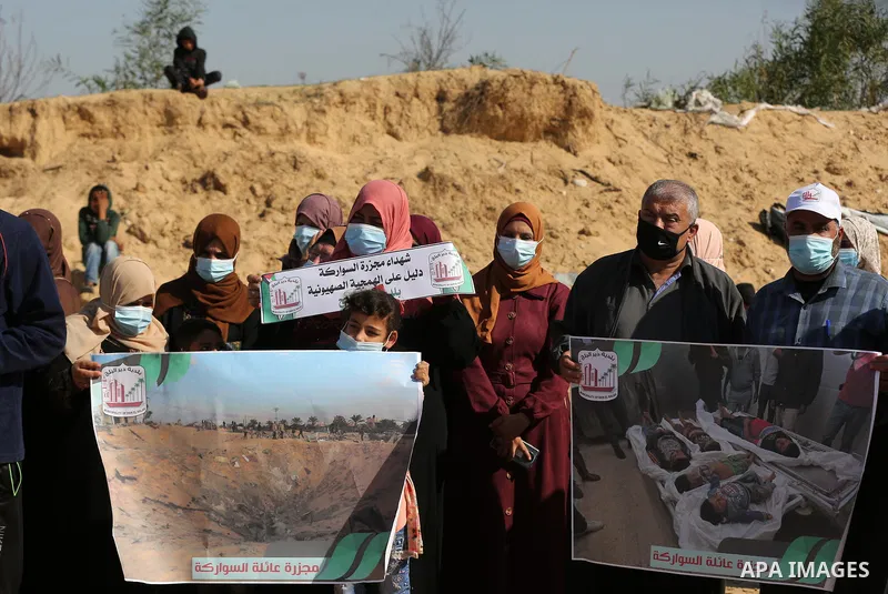 Palestinians take part in a protest on the first anniversary of the massacre of the "Al-Sawarka" family who were killed hit by an Israeli airstrike, in Deir al-Balah, central of Gaza Strip on November 19, 2020. Israel sa...