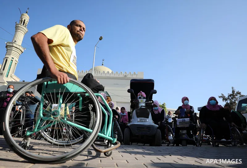 Palestinian disabilities participate in a marathon to mark the International Day of Disabled in Gaza City, on December 3, 2020. The observance of the Day aims to promote an understanding of disability issues and mobilize...
