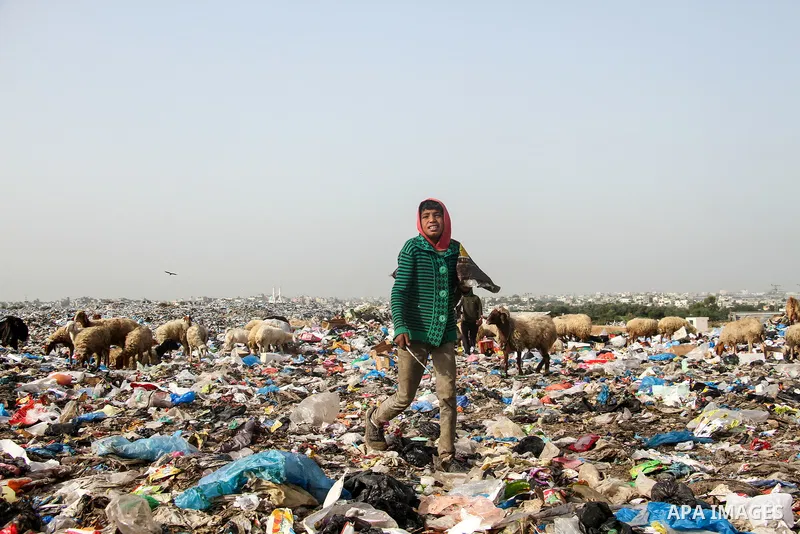 Palestinian children collect scrap from a garbage dump in the Bedouin village of "Umm Al-Nasr" in the northern Gaza Strip, on December 9, 2020. When the COVID-19 pandemic struck worldwide, humanitarian organizations in t...