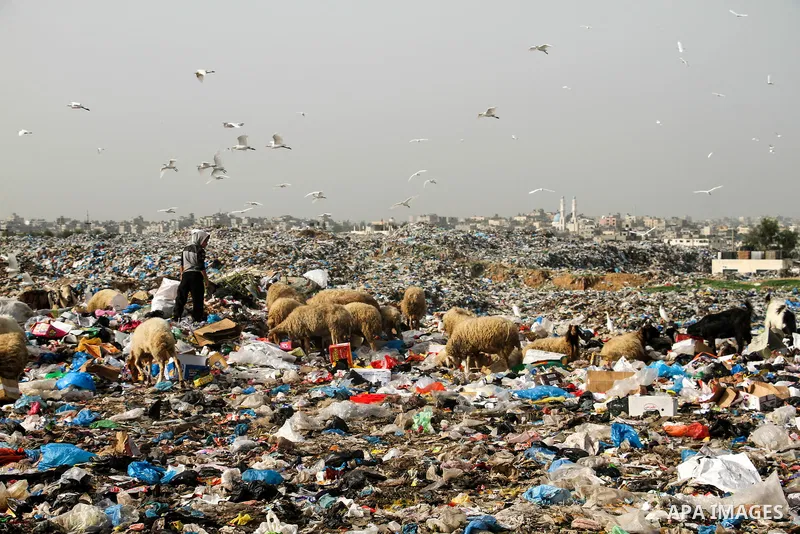 Palestinian children collect scrap from a garbage dump in the Bedouin village of "Umm Al-Nasr" in the northern Gaza Strip, on December 9, 2020. When the COVID-19 pandemic struck worldwide, humanitarian organizations in t...
