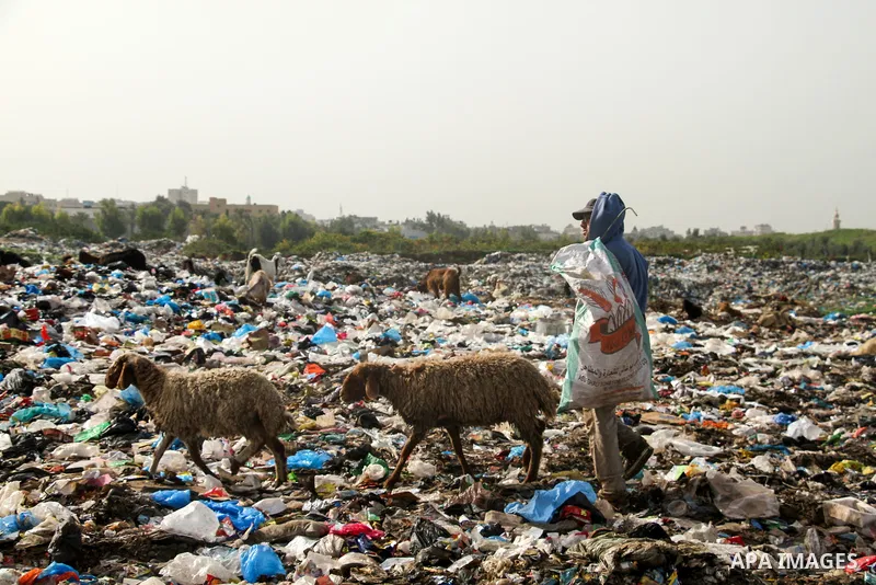 Palestinian children collect scrap from a garbage dump in the Bedouin village of "Umm Al-Nasr" in the northern Gaza Strip, on December 9, 2020. When the COVID-19 pandemic struck worldwide, humanitarian organizations in t...