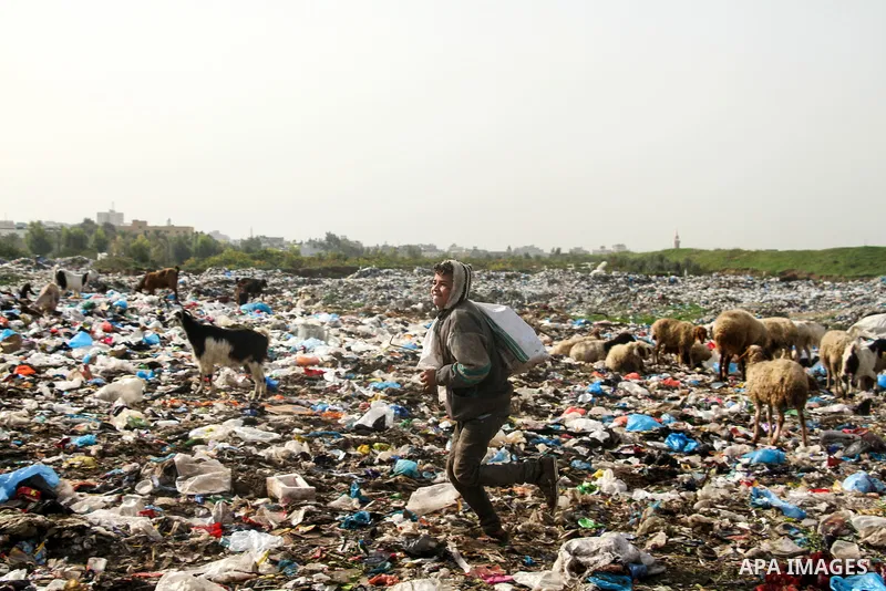 Palestinian children collect scrap from a garbage dump in the Bedouin village of "Umm Al-Nasr" in the northern Gaza Strip, on December 9, 2020. When the COVID-19 pandemic struck worldwide, humanitarian organizations in t...