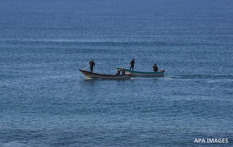 Palestinian policemen board their boat at sea in Mediterranean Sea during a complete closure amid the spread of the Coronavirus COVID-19, in Deir al-Balah, central of Gaza Strip, on December 25, 2020, in the third week a...