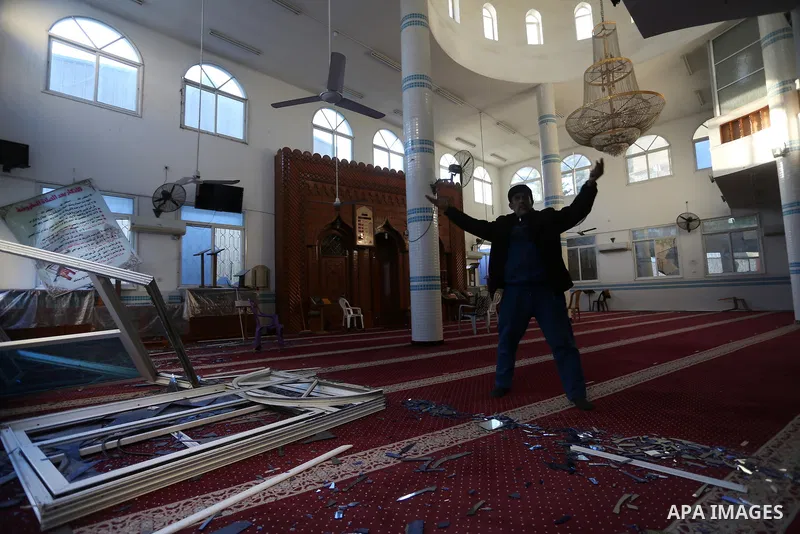 A Palestinian man inspects the damage a mosque following Israeli airstrikes, in Gaza City, on December 26, 2020. Israel targeted a number of sites in Gaza after Palestinian militants fired rockets into the south of the c...
