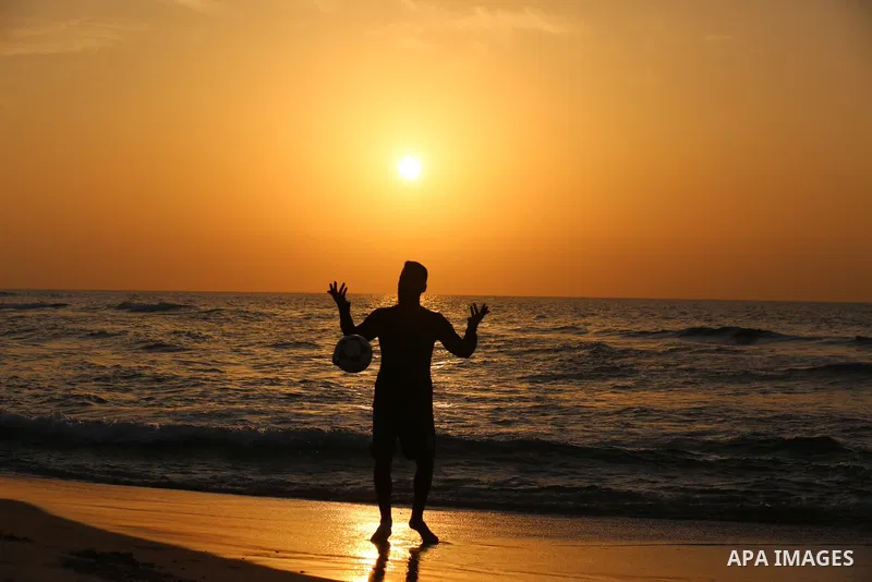 Palestinians enjoy their time on the beach during sunset in the last day of 2020, before the complete closure amid the spread of the Coronavirus COVID-19, in Gaza City on December 31, 2020, in the fourth week after the M...